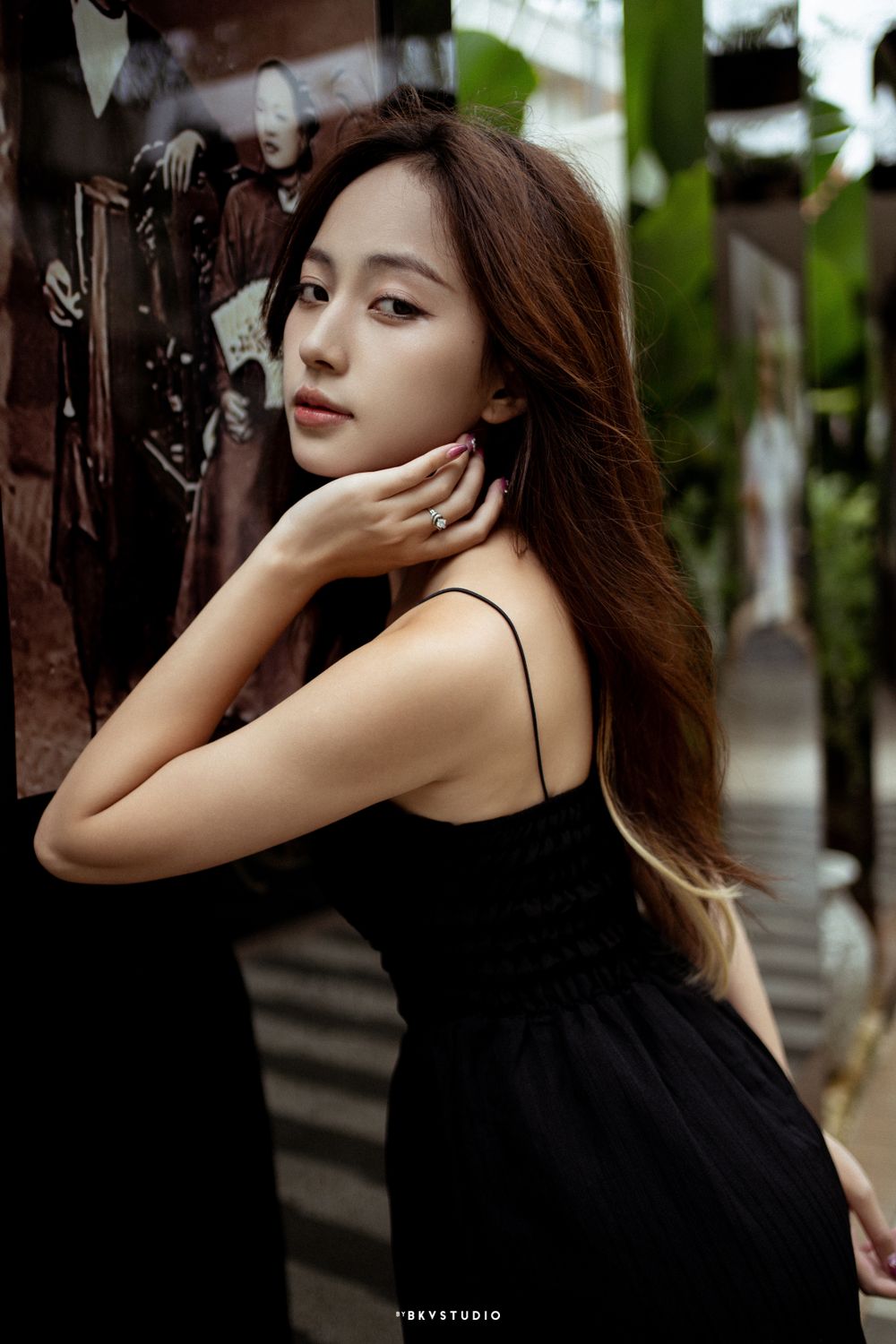 Romantic portrait in black dress with gentle natural lighting.