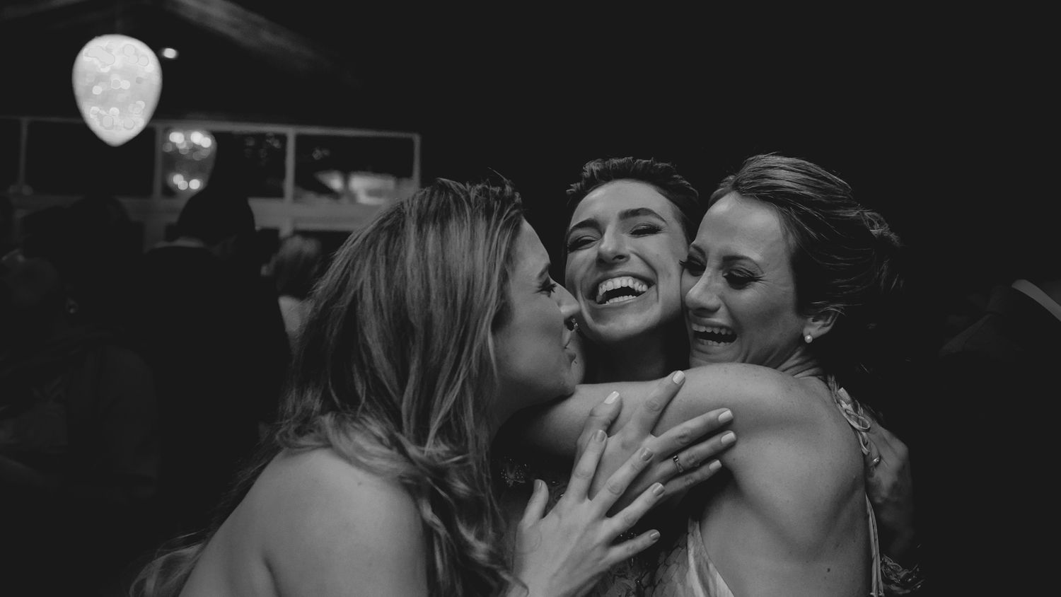 Black and white candid photo capturing joyful emotions during a wedding celebration.