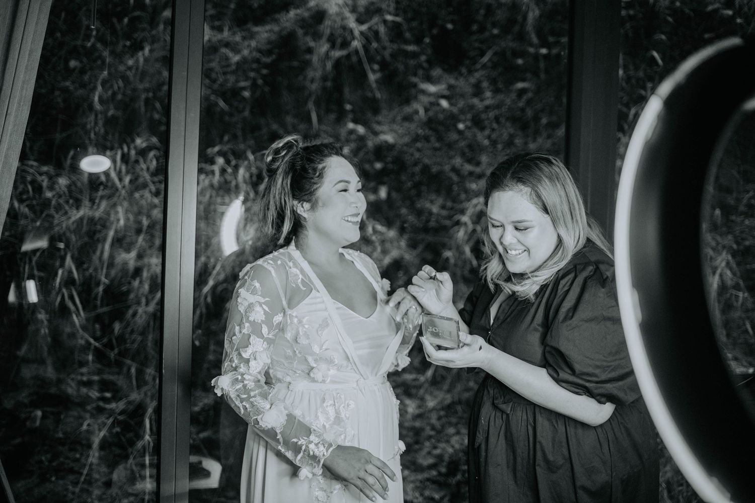 Black and white photo showing preparations for a special event in a mirrored room.