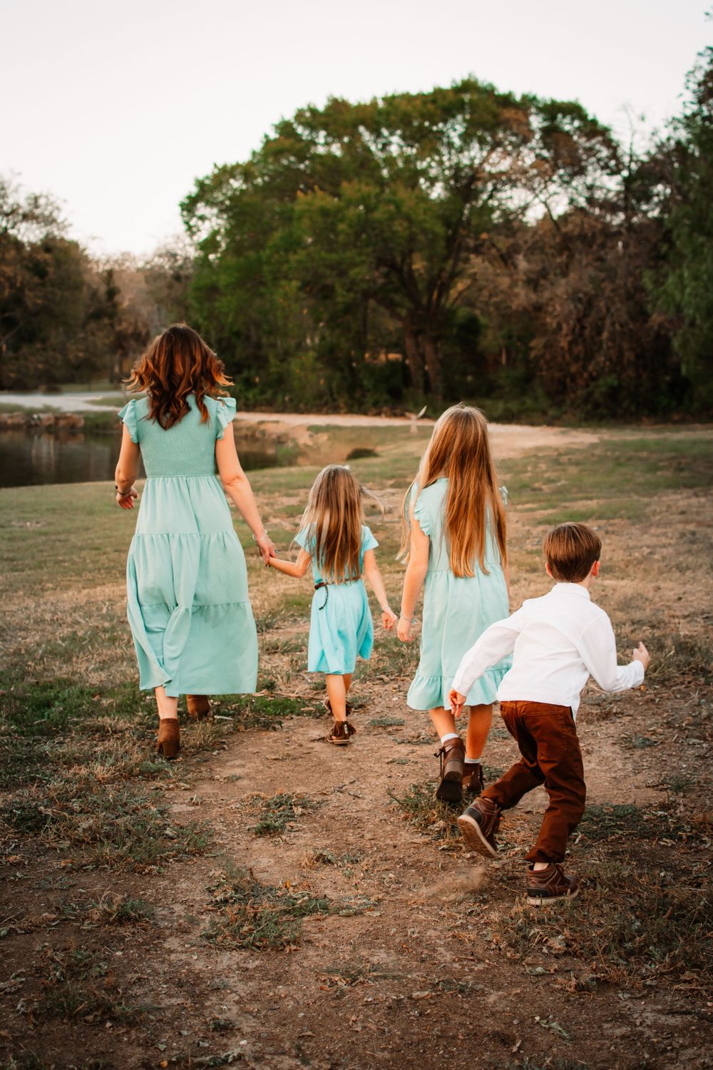 Candid family portrait in DFW with young children playing together in natural ligh