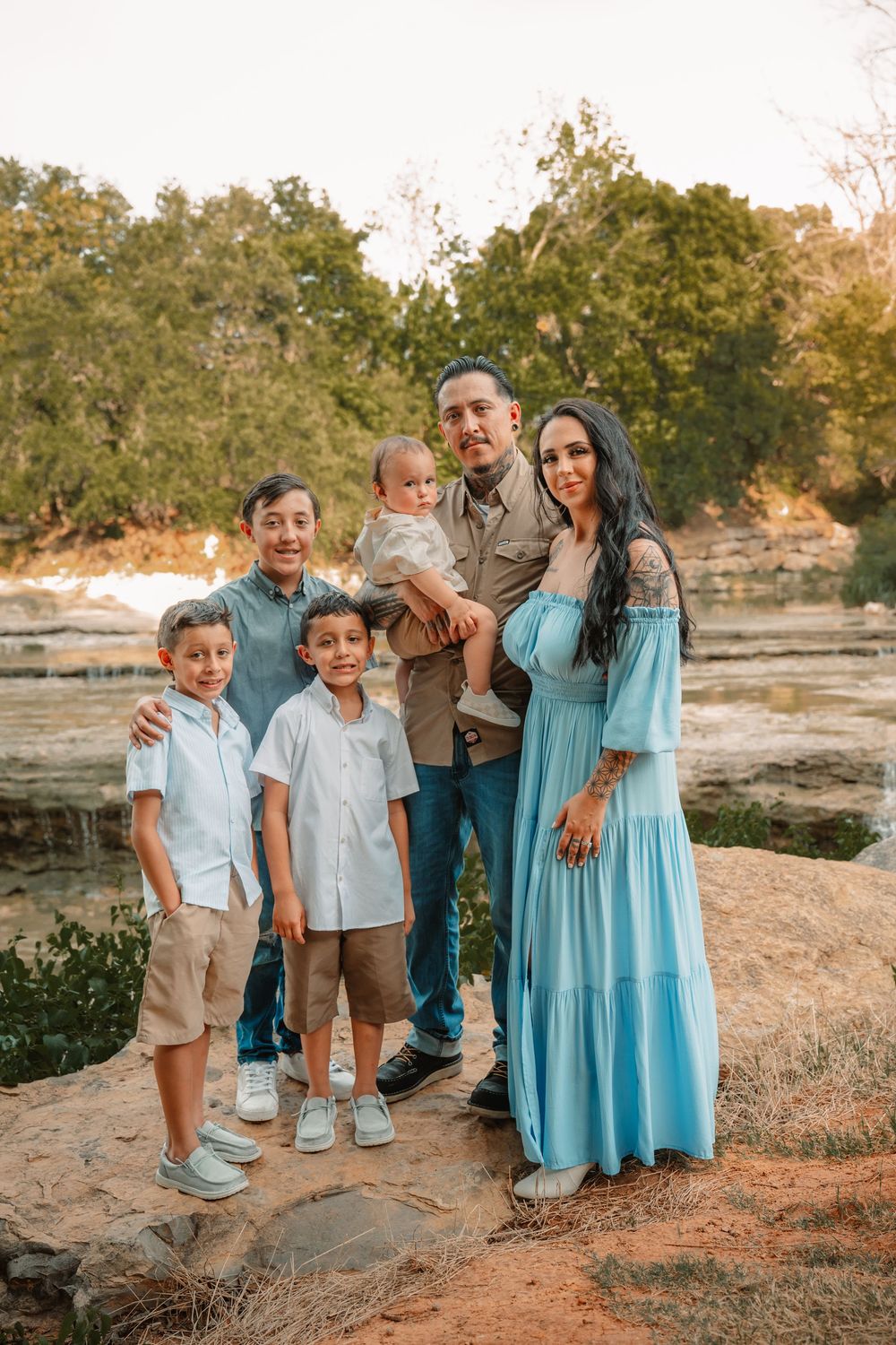 Dallas–Fort Worth family photography session with parents and children outdoors in front of a waterfall