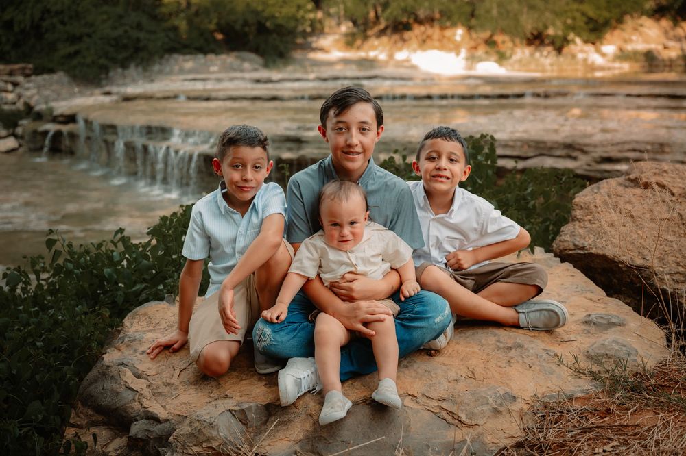 posed family photos in front of waterfall in Fort Worth Texas