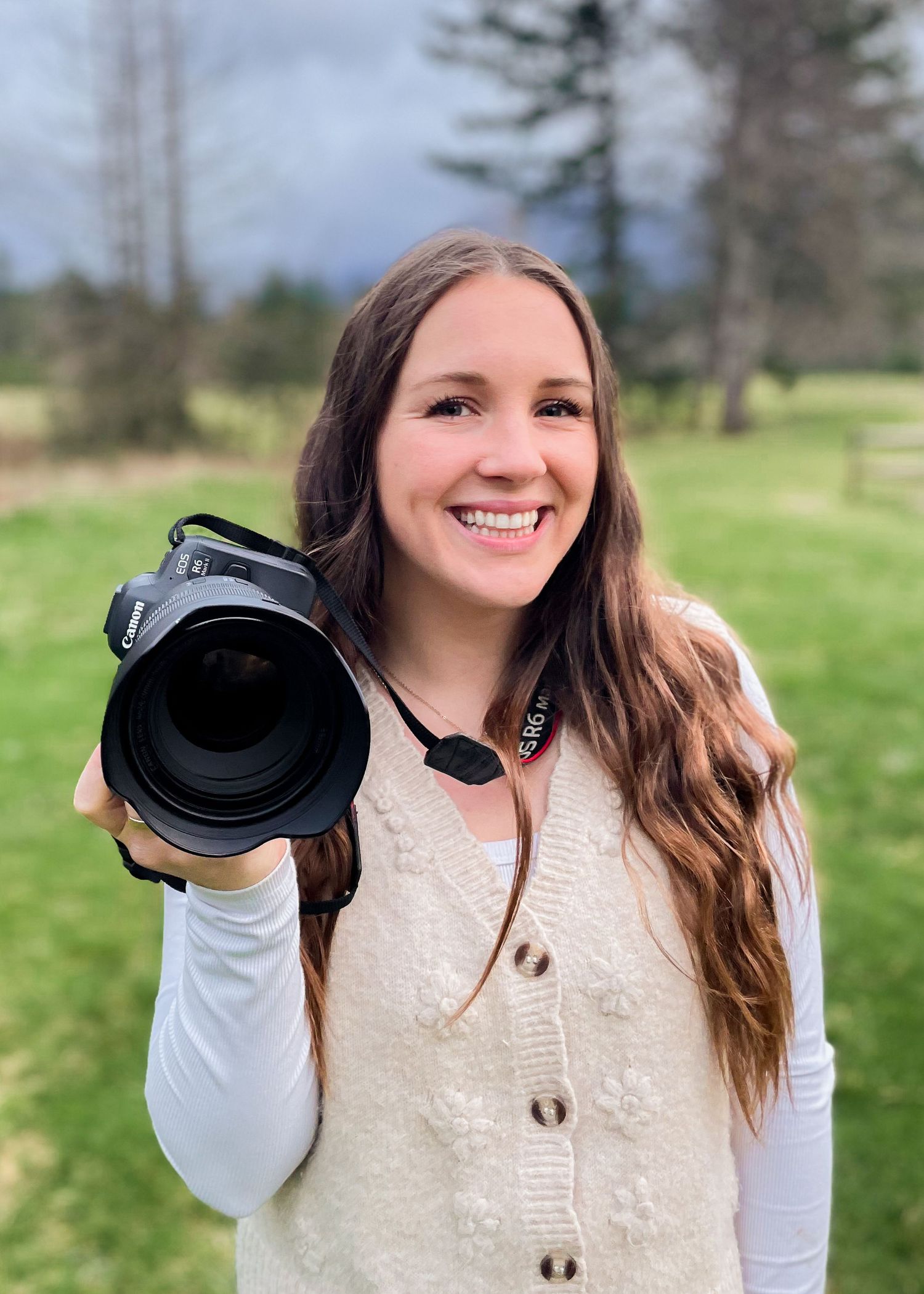 Photographer with camera laughs and is happy