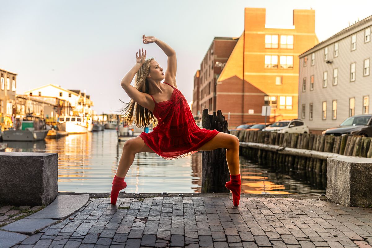 Series of urban parkour moves showing a person in red clothing performing dynamic jumps and flips against walls at sunset.