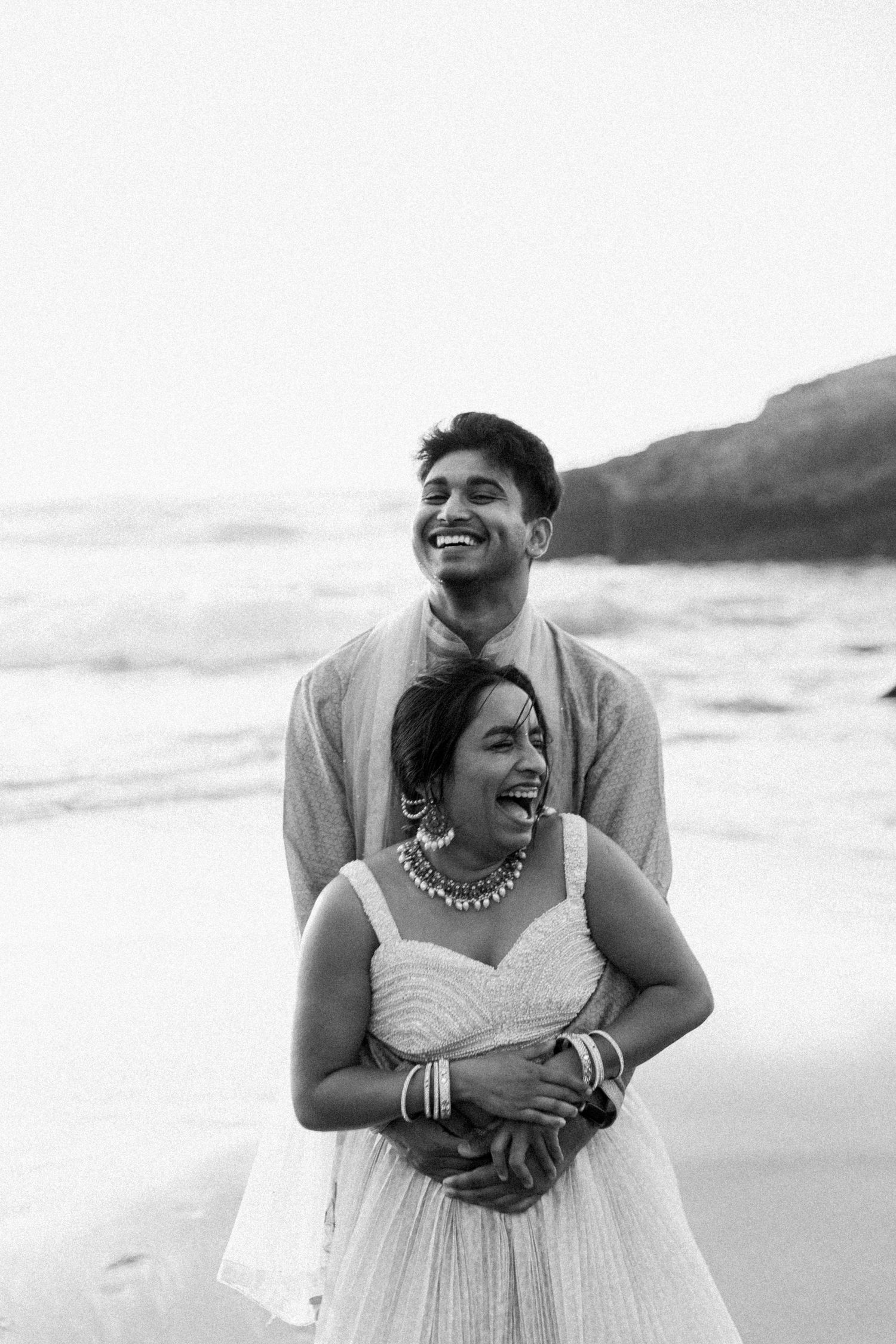 man and woman embrace with hands on cheeks after getting engaged in Pinecrest, California