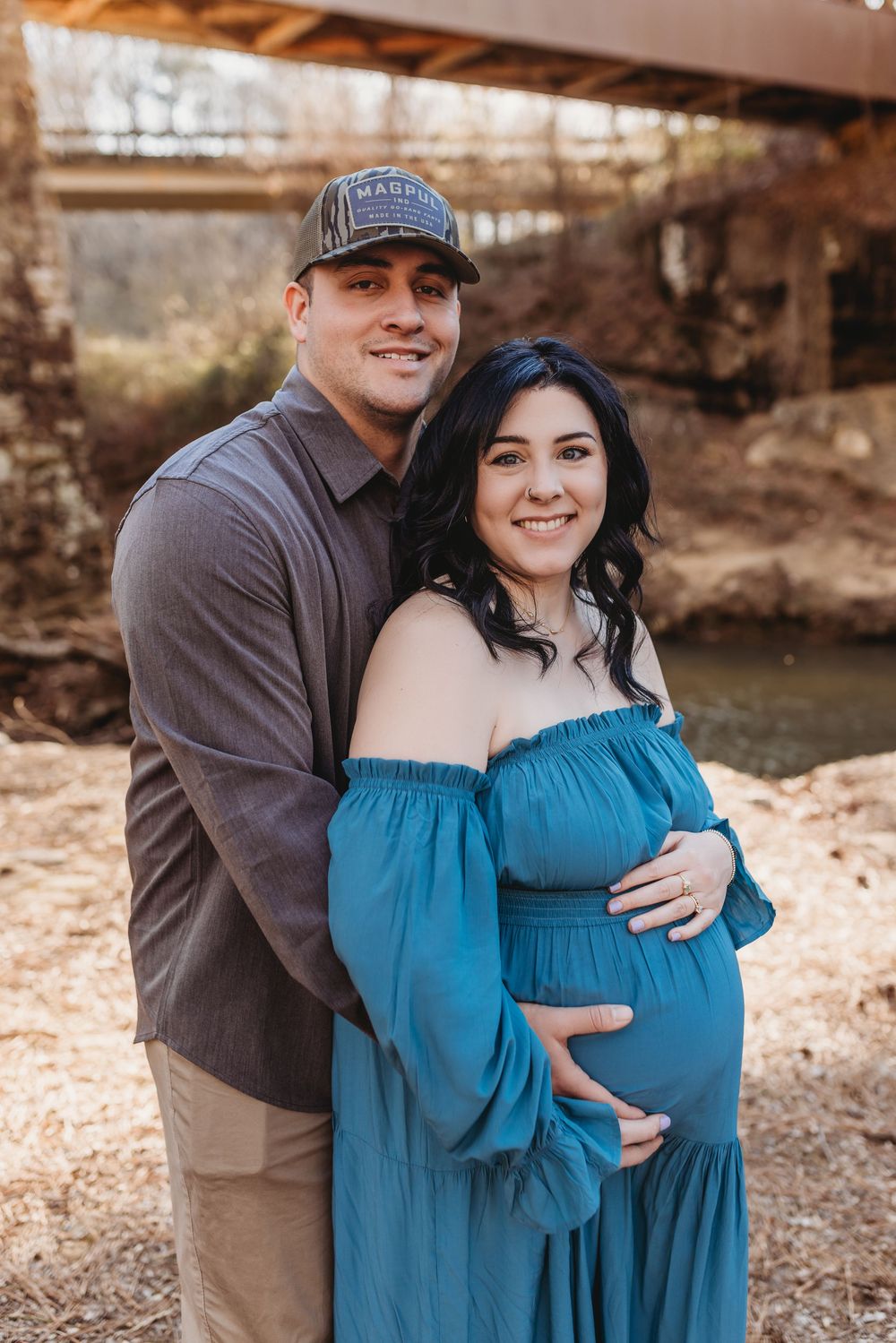 A North Alabama maternity photoshoot at Clarkson Covered Bridge in Cullman, AL. Beautiful maternity gown photos with family