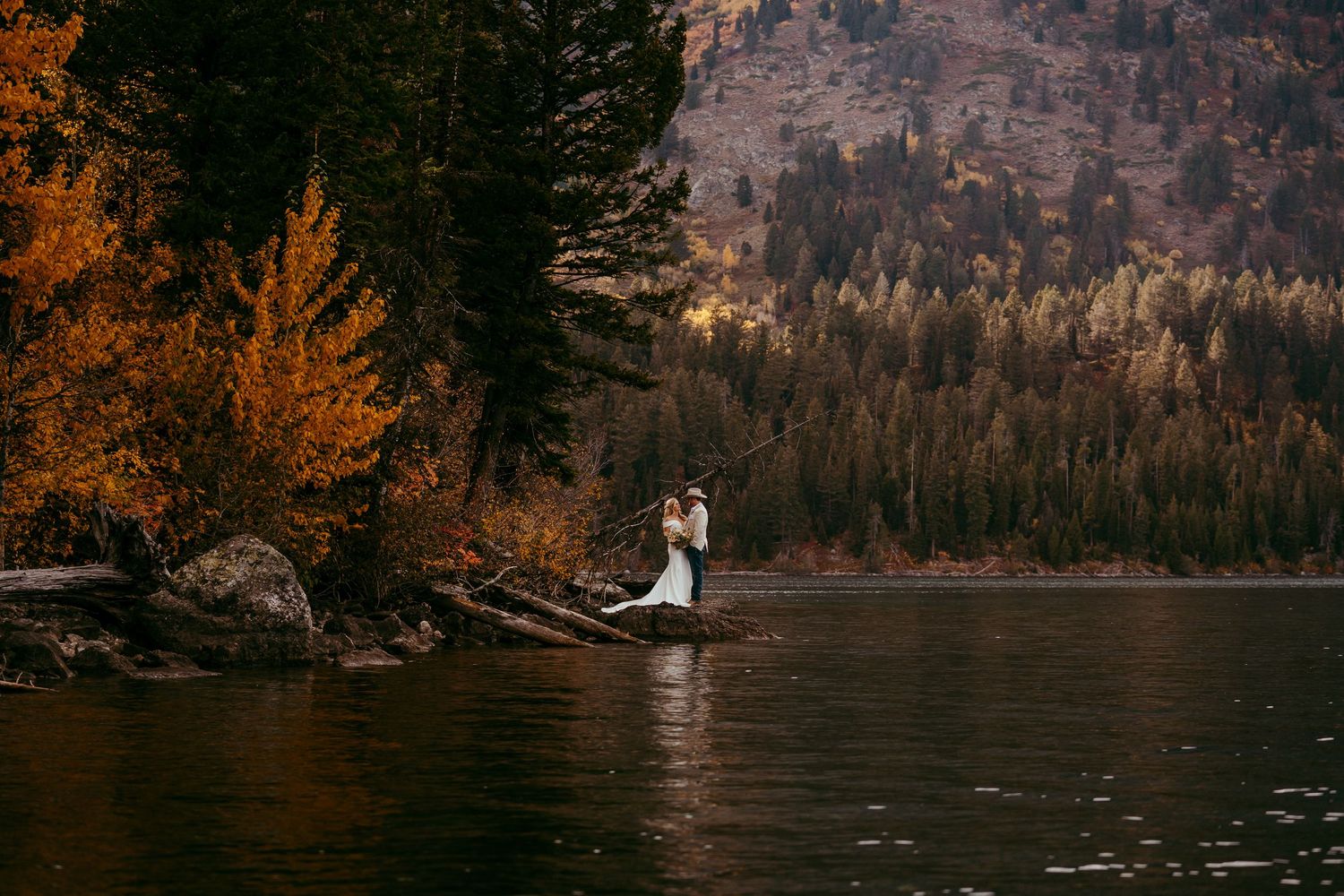 Bride and groom embracing in front of the Grand Tetons in Jackson Hole