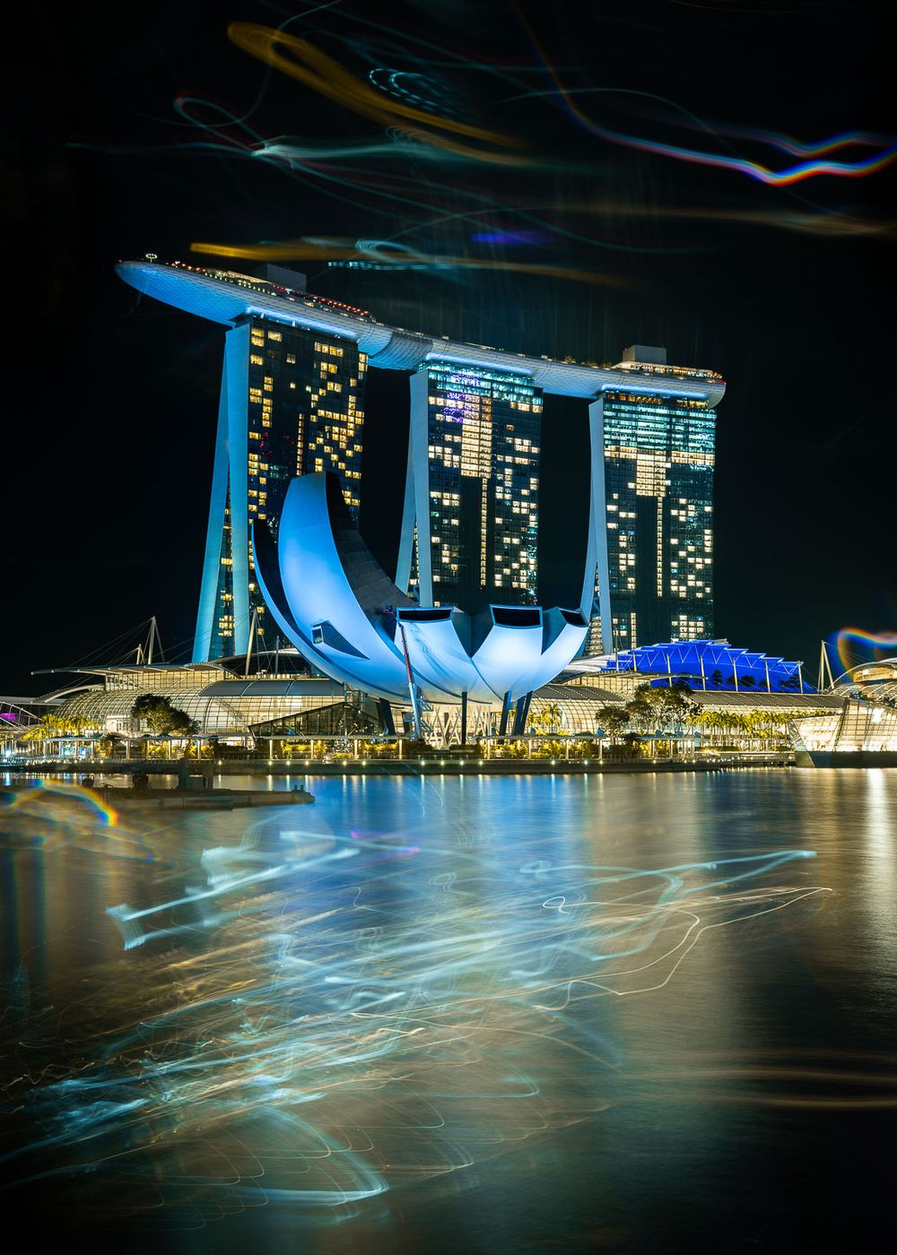 Marina Bay Sands and the ArtScience Museum glow at night above the reflective waters of Singapore's Marina Bay.