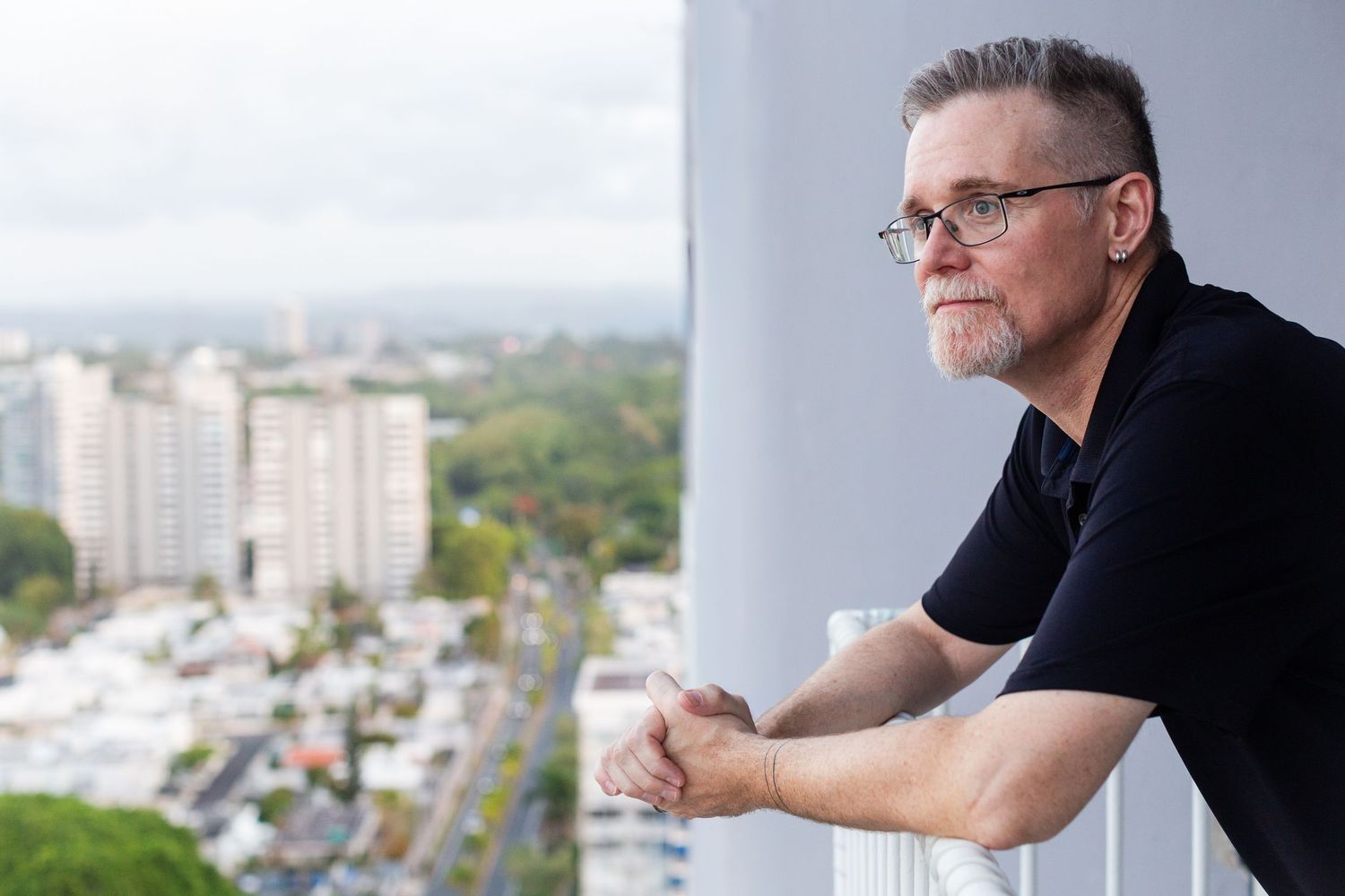 Portrait of a man on a condo balcony. Guaynabo, Puerto Rico.