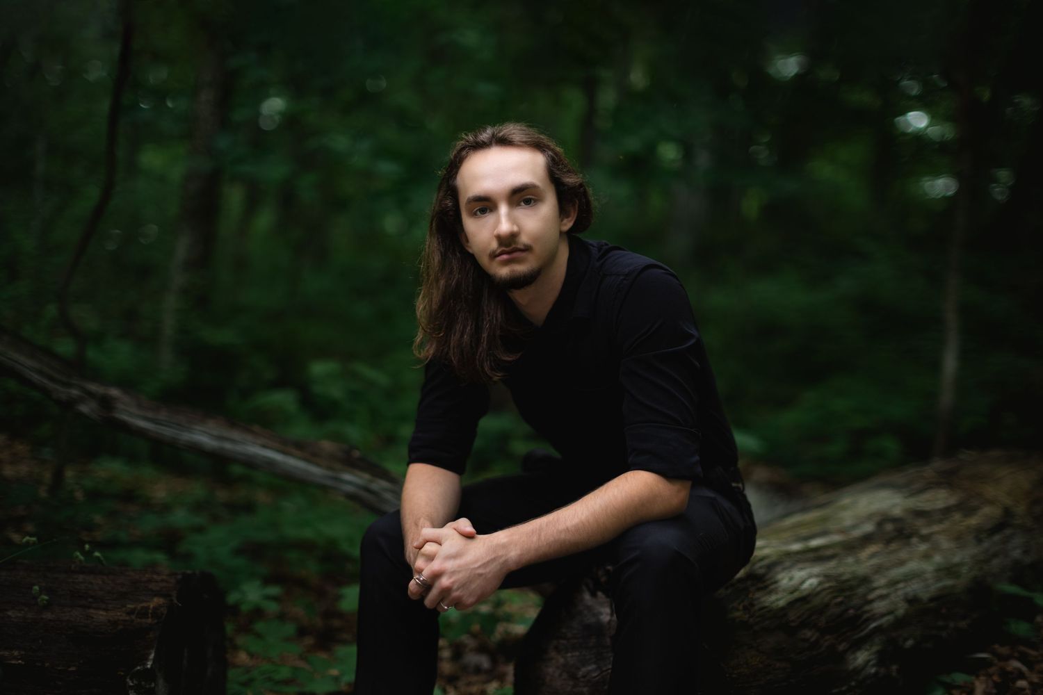 High school senior photo with film aesthetic in Pinckney, MI woods with moody light by South Lyon, MI senior portrait photographer