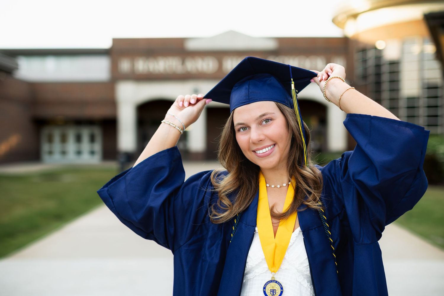 Smiling high school graduate cap and gown photo in Hartland, MI by Brighton Michigan senior portrait photographer