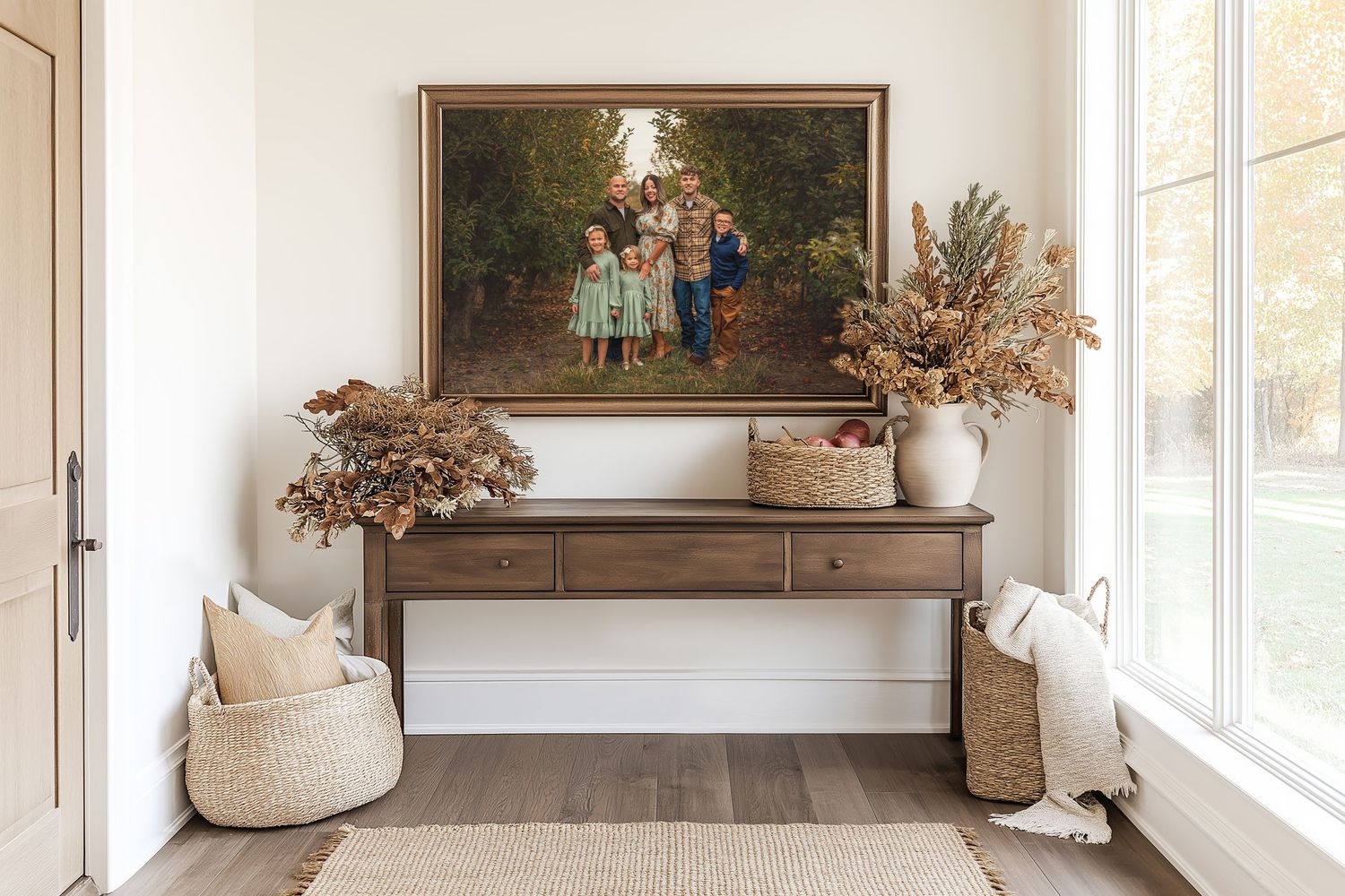 Rustic entryway console table with dried floral arrangements, woven baskets, and a framed family portrait on the wall.