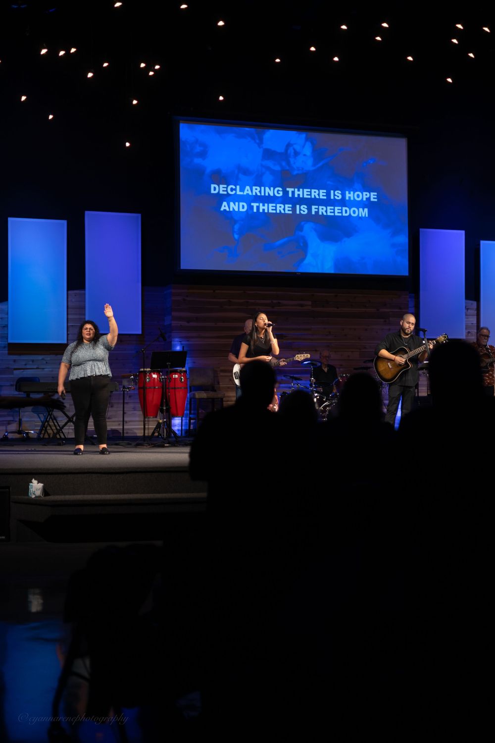 Worship team performing on stage at Victory Assembly of God church with hope and freedom lyrics displayed on screen.