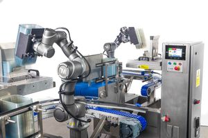 Industrial robotic arms on an automated assembly line machine in a modern manufacturing facility.