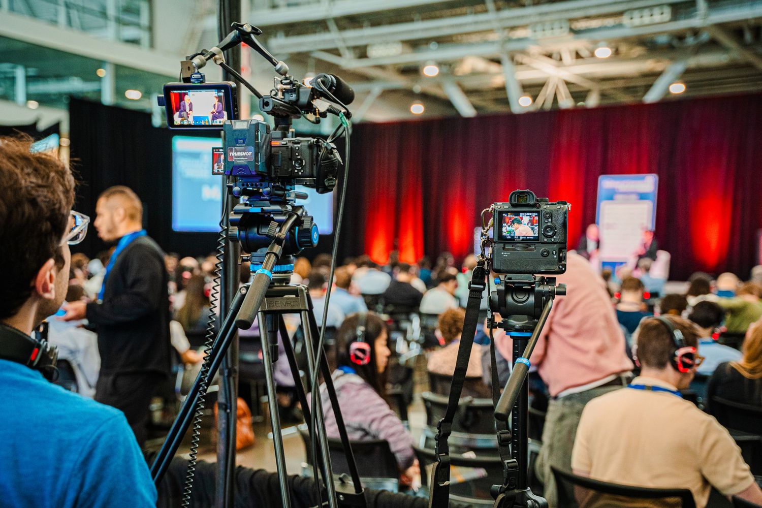 Camera equipment used by Boston event photographer Dylan Kaufman shooting towards stage at a conference.