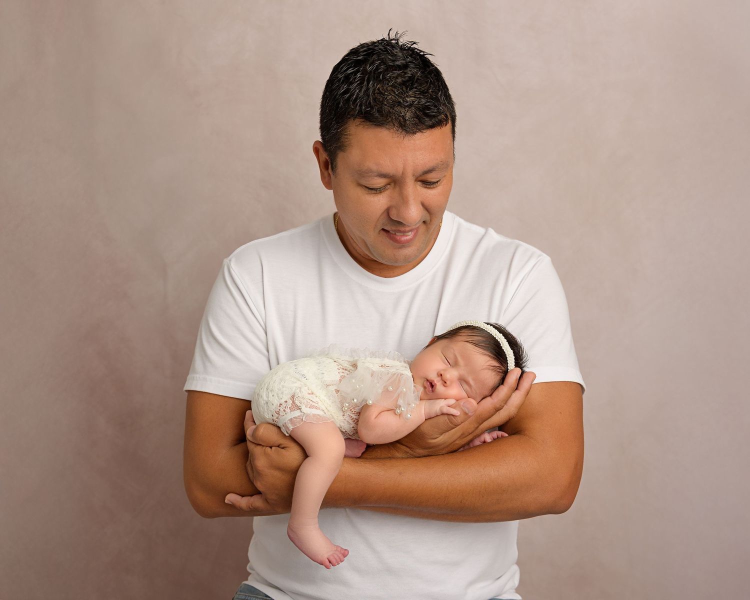 Father holding his newborn daughter during a Tampa FL newborn photography session