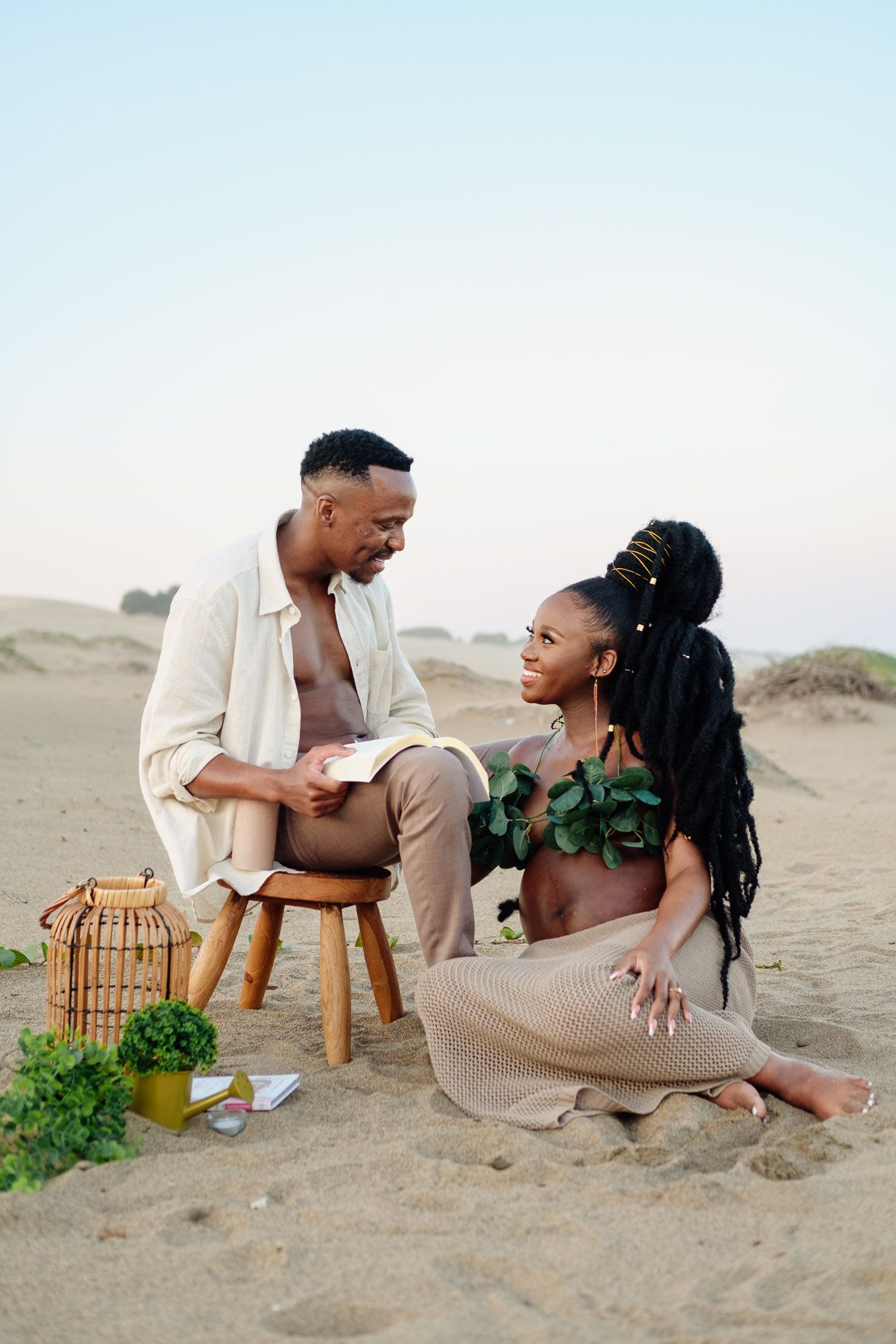 Expecting couple sharing a loving moment on the beach during a maternity session