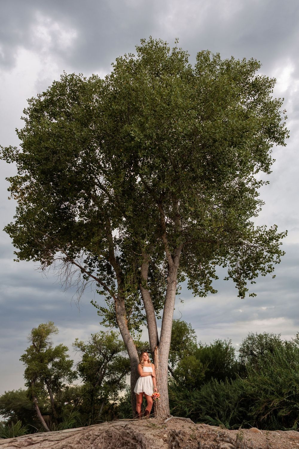 Western Tucson Senior pictures session in the Desert with stormy sky at Tanque Verde Guest Ranch