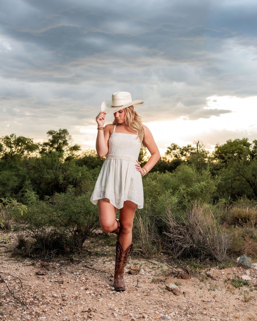 Western Tucson Senior pictures session in the Desert with stormy sky at Tanque Verde Guest Ranch