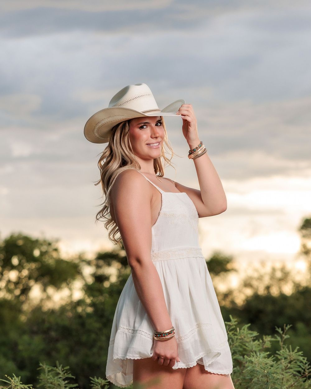 Western Tucson Senior pictures session in the Desert with stormy sky at Tanque Verde Guest Ranch