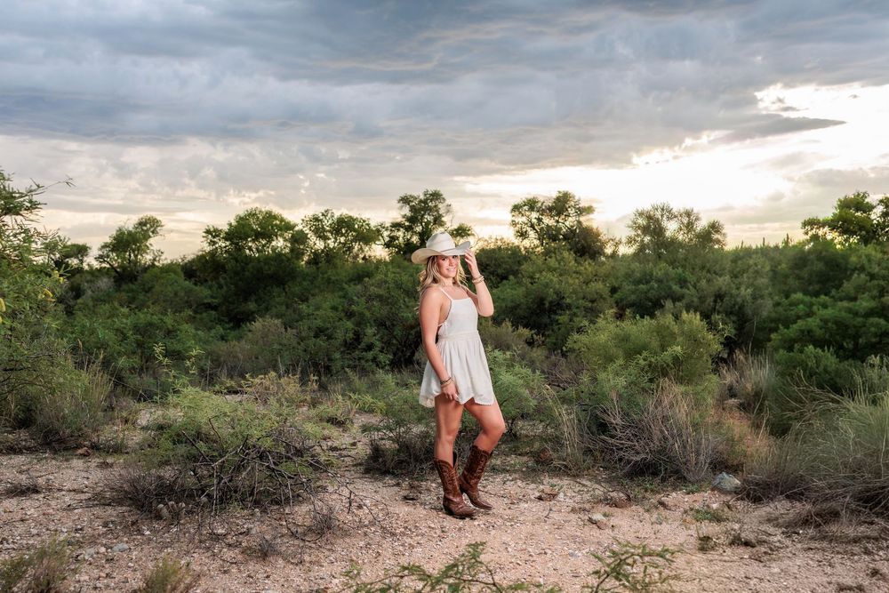 Western Tucson Senior pictures session in the Desert with stormy sky at Tanque Verde Guest Ranch