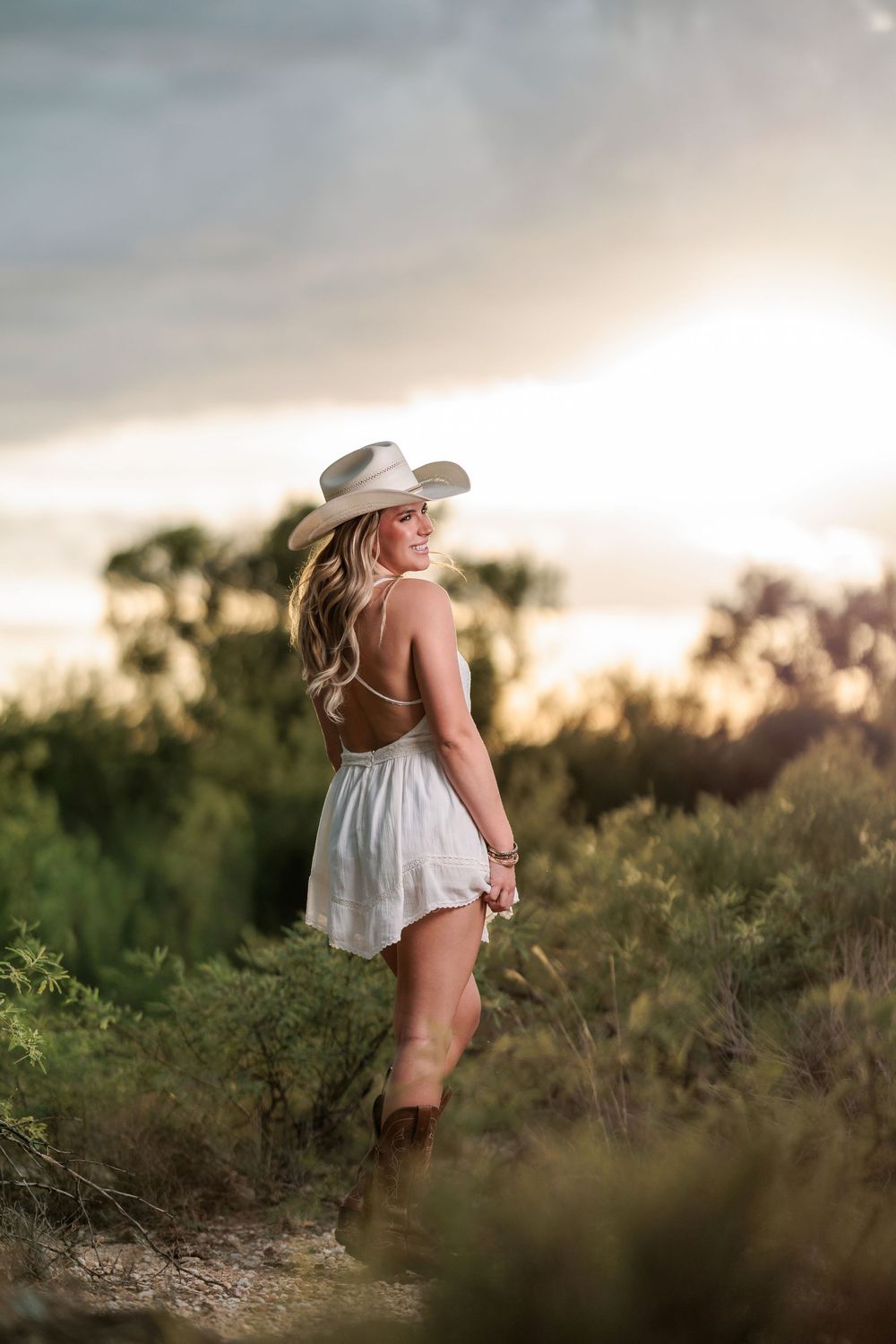 Western Tucson Senior pictures session in the Desert with stormy sky at Tanque Verde Guest Ranch