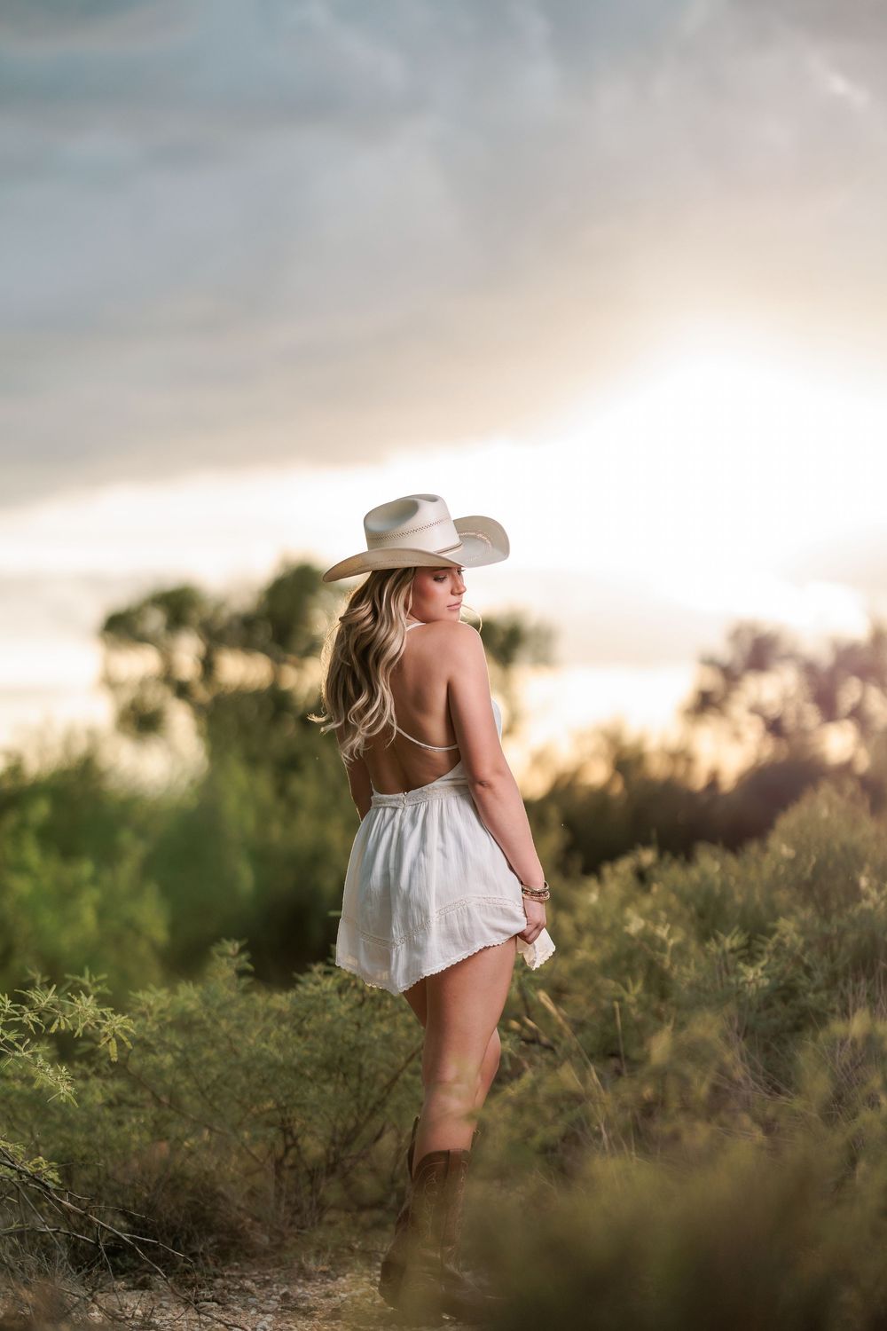 Western Tucson Senior pictures session in the Desert with stormy sky at Tanque Verde Guest Ranch
