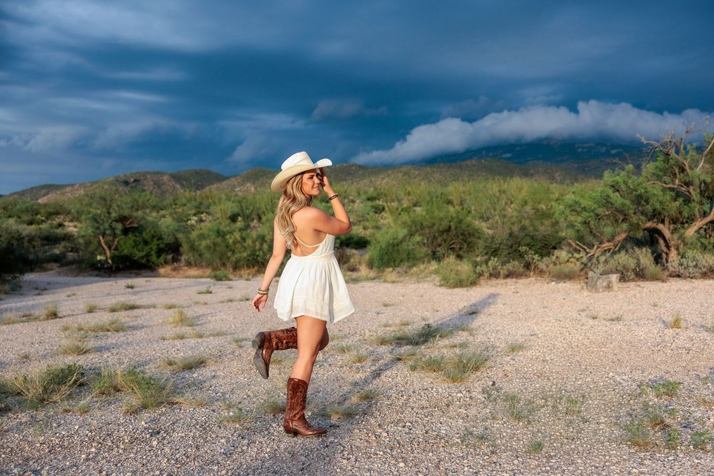 Western Tucson Senior pictures session in the Desert with stormy sky at Tanque Verde Guest Ranch