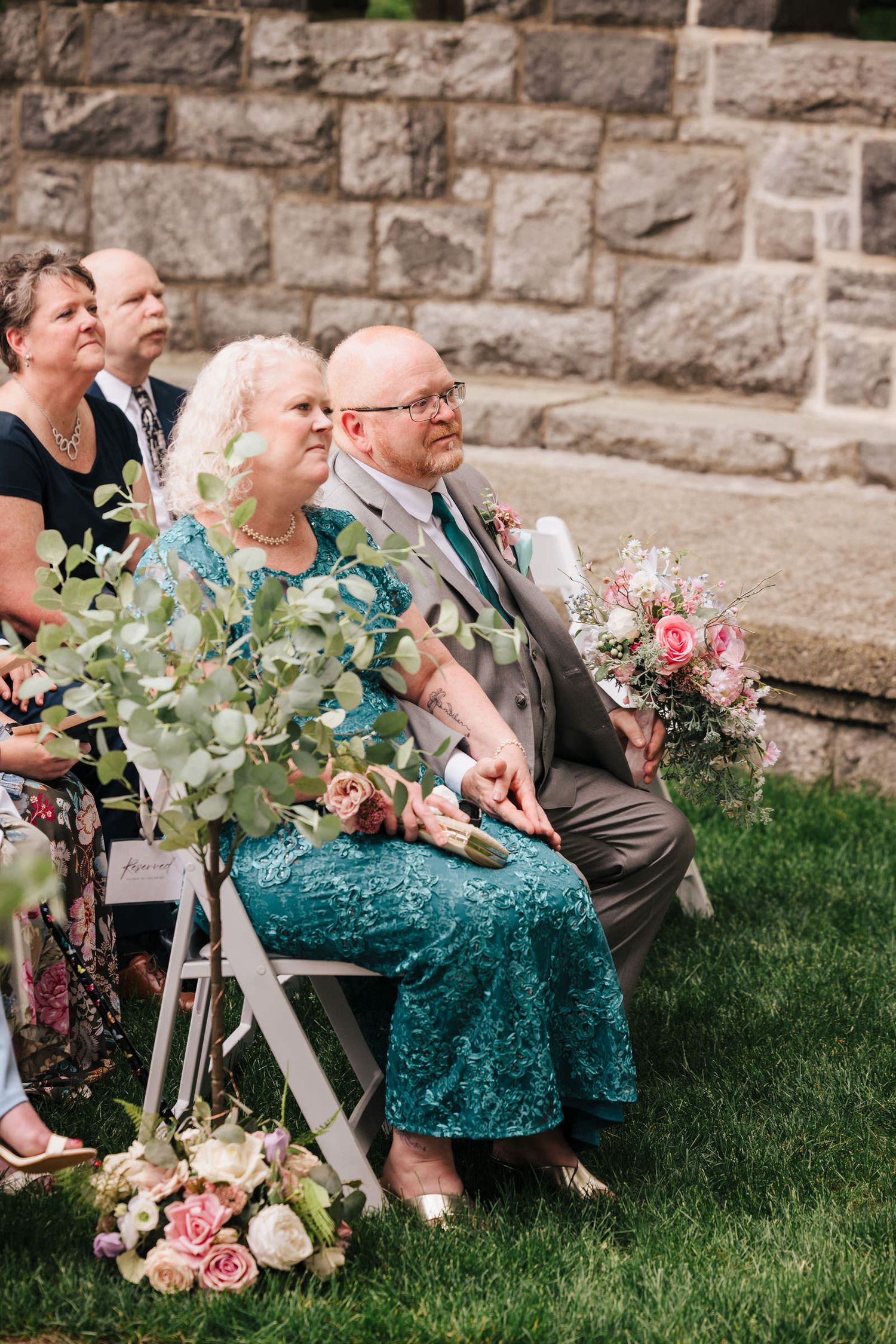 Bride and groom facing the officiant during their vows, bride visibly emotional, at Searles Castle.