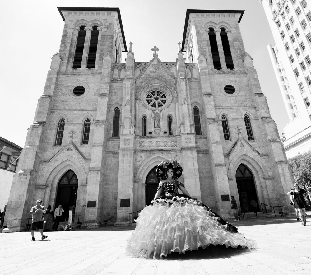 Black and white photo of a grand cathedral with a dramatic dress silhouette in the foreground.