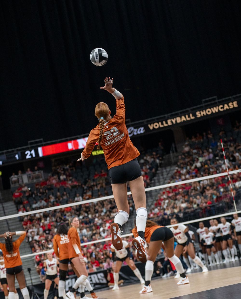 Texas Longhorns player #23 leaps to hit the ball during the Players Era Volleyball Showcase match.