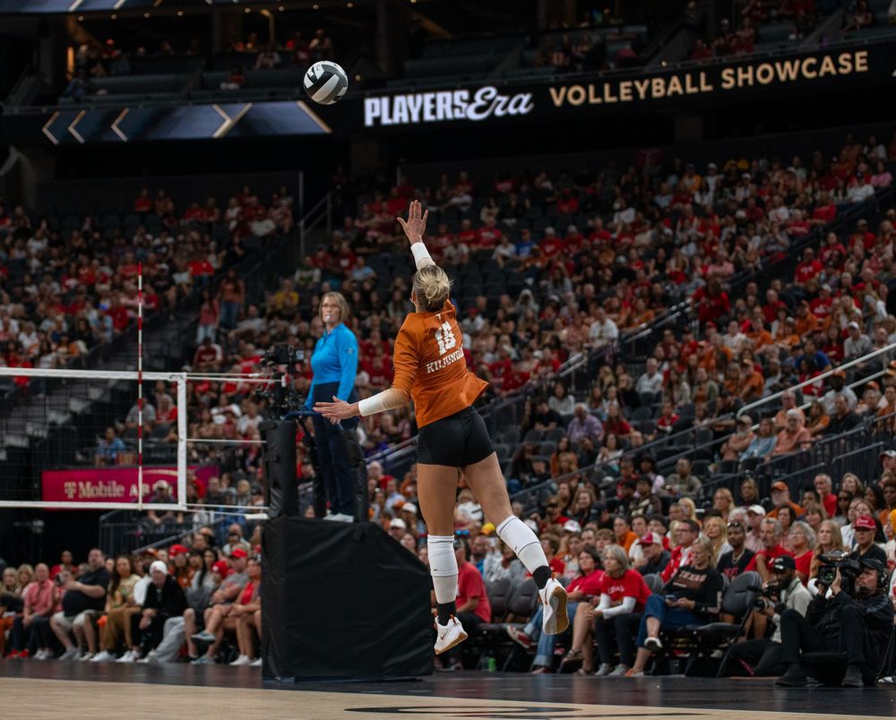 Texas Longhorns volleyball player jumps to spike the ball at the Players Era Volleyball Showcase.