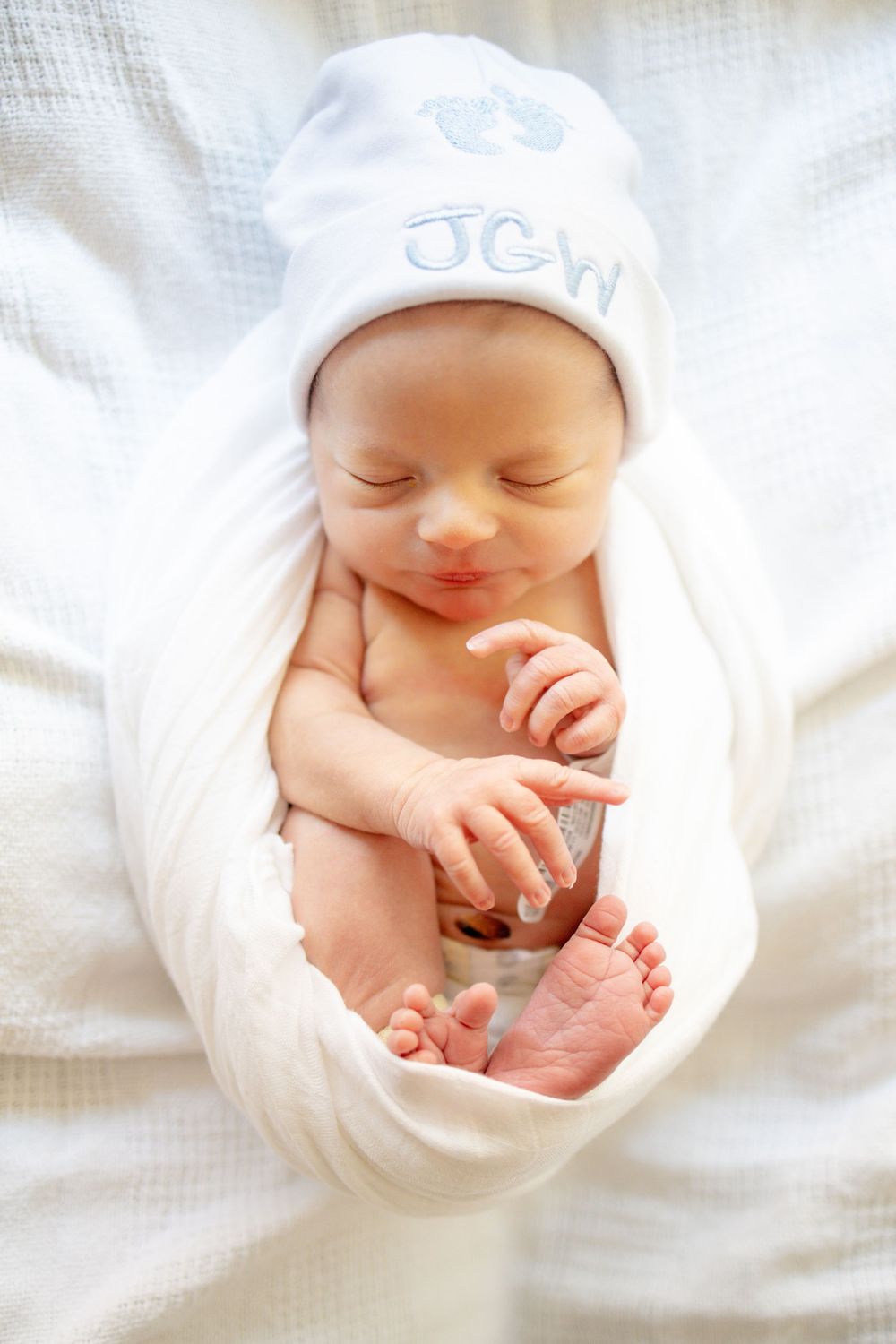 Sleeping newborn baby wrapped in white swaddle blanket University of Tennessee Medical Center.