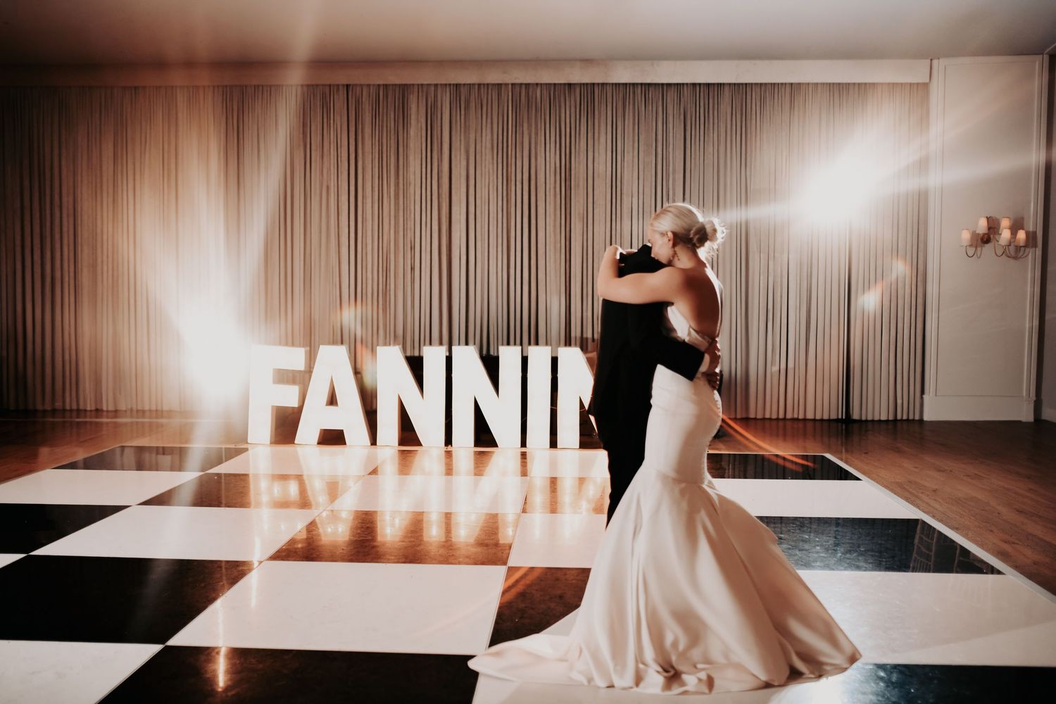 Newlyweds alone on the dance floor at the end of their wedding night
