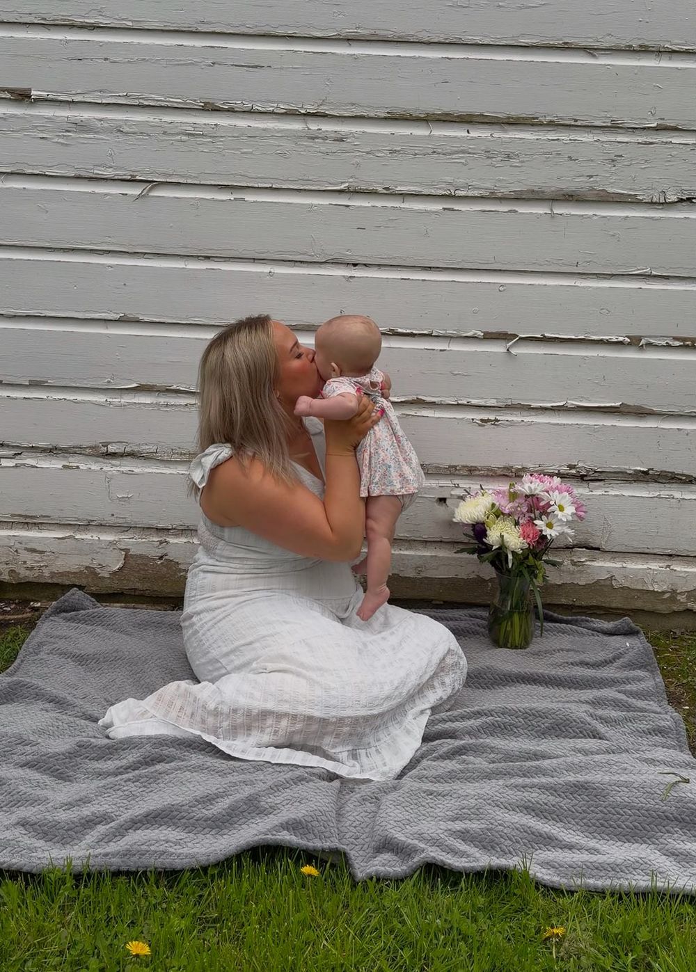 Mother kissing her baby during an outdoor motherhood photography session