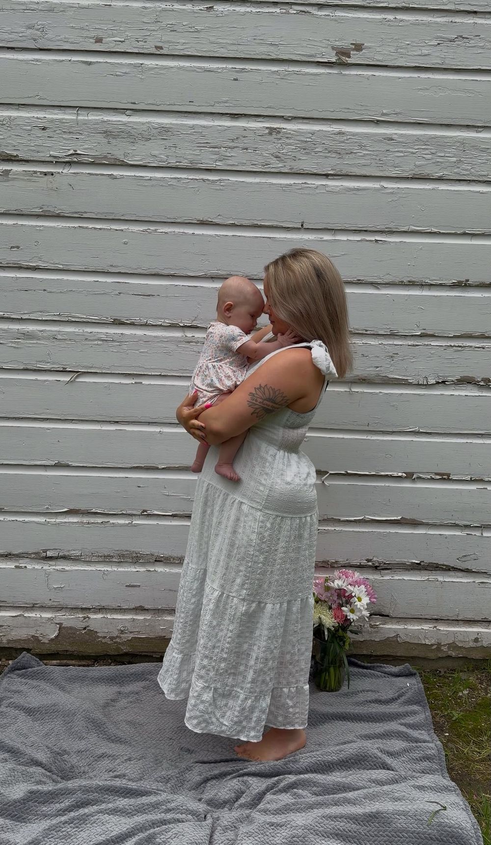 Mother holding her baby during an outdoor motherhood photography session