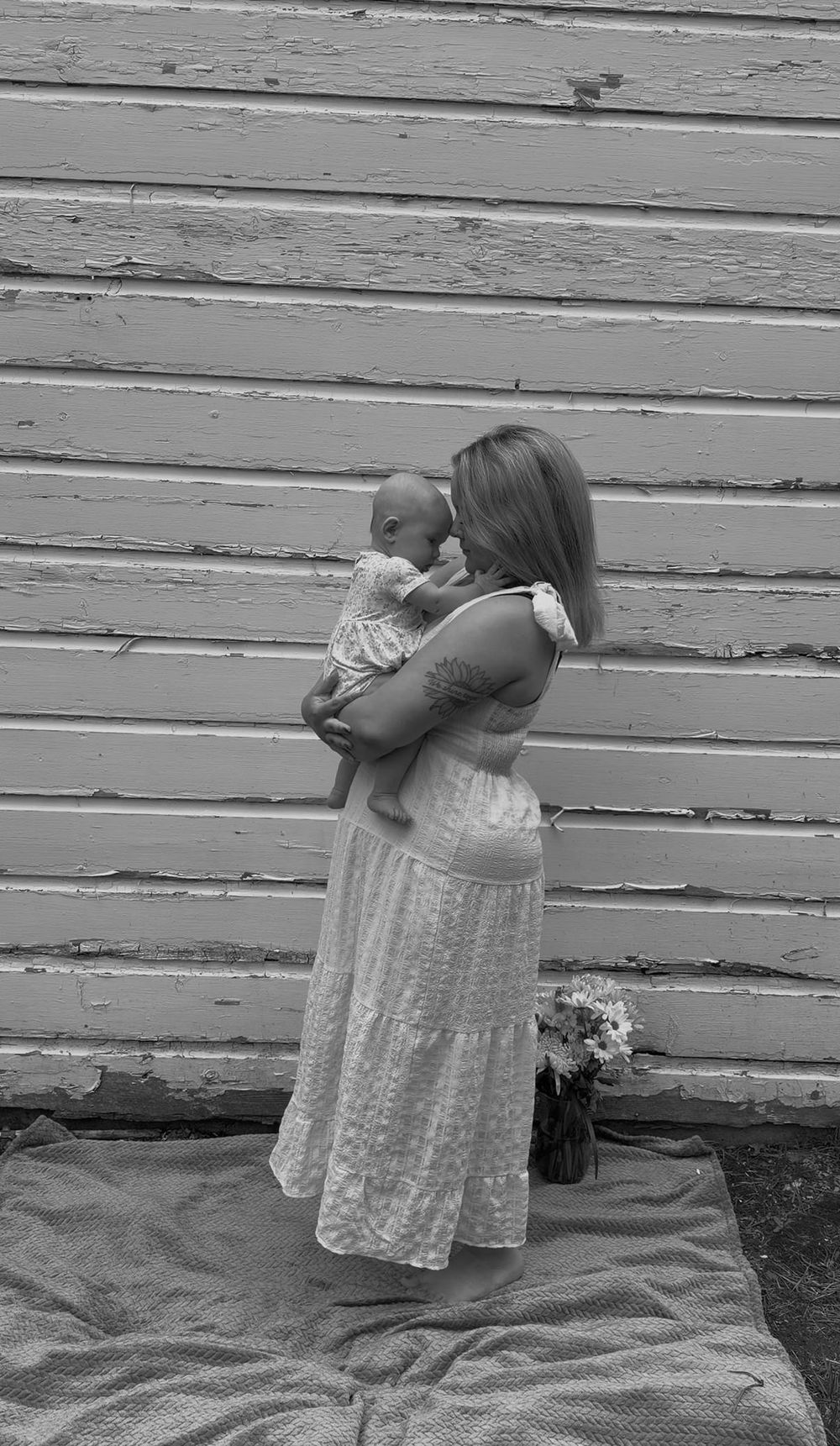 Mother holding her baby during an outdoor motherhood photography session