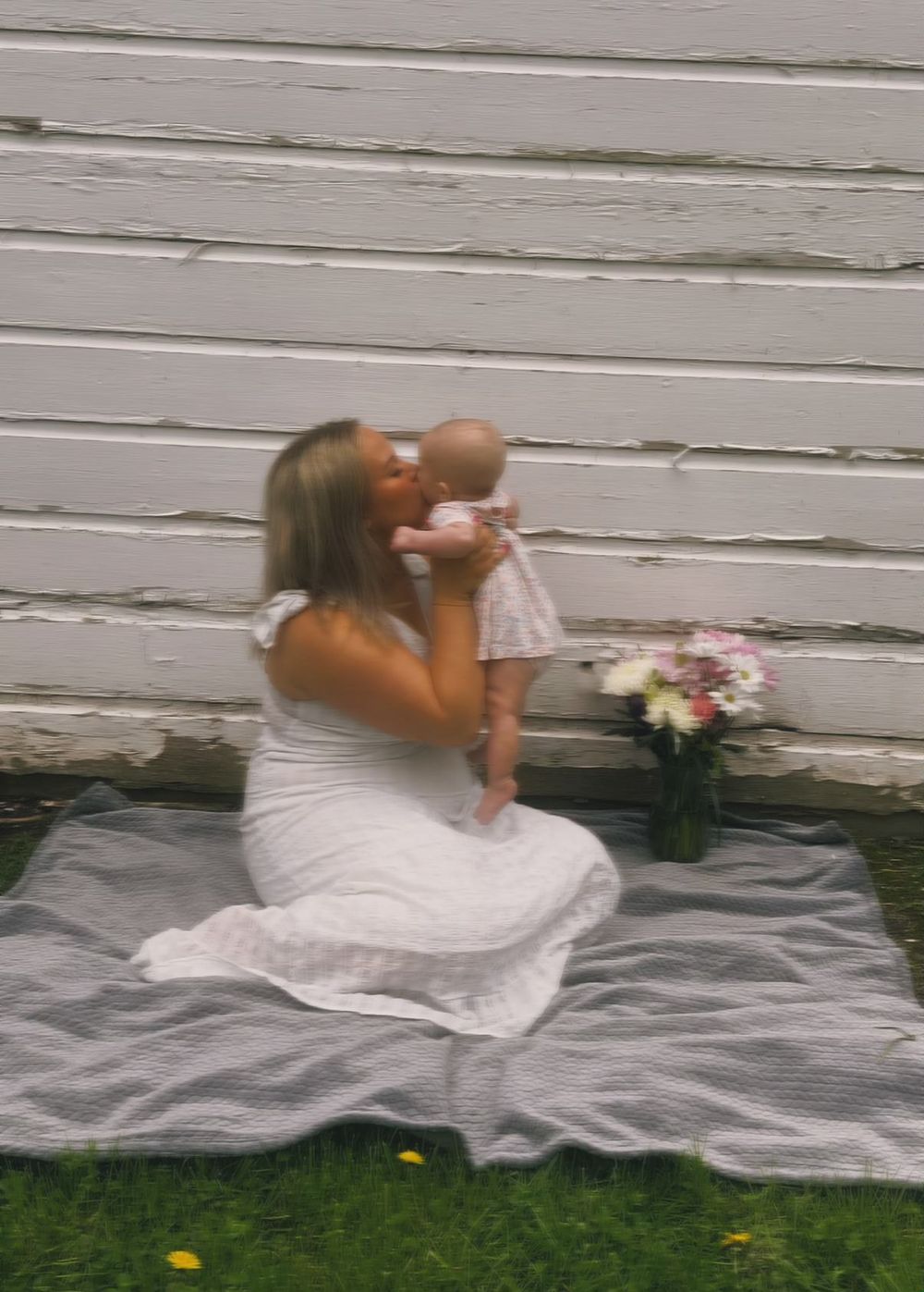 Mother kissing her baby during an outdoor motherhood photography session