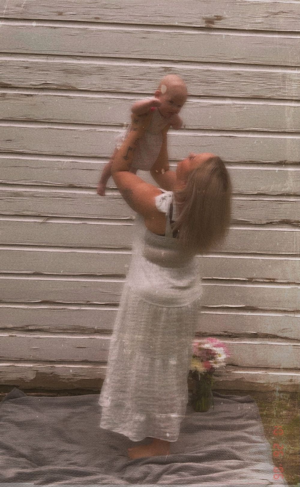 Mother holding her baby during an outdoor motherhood photography session