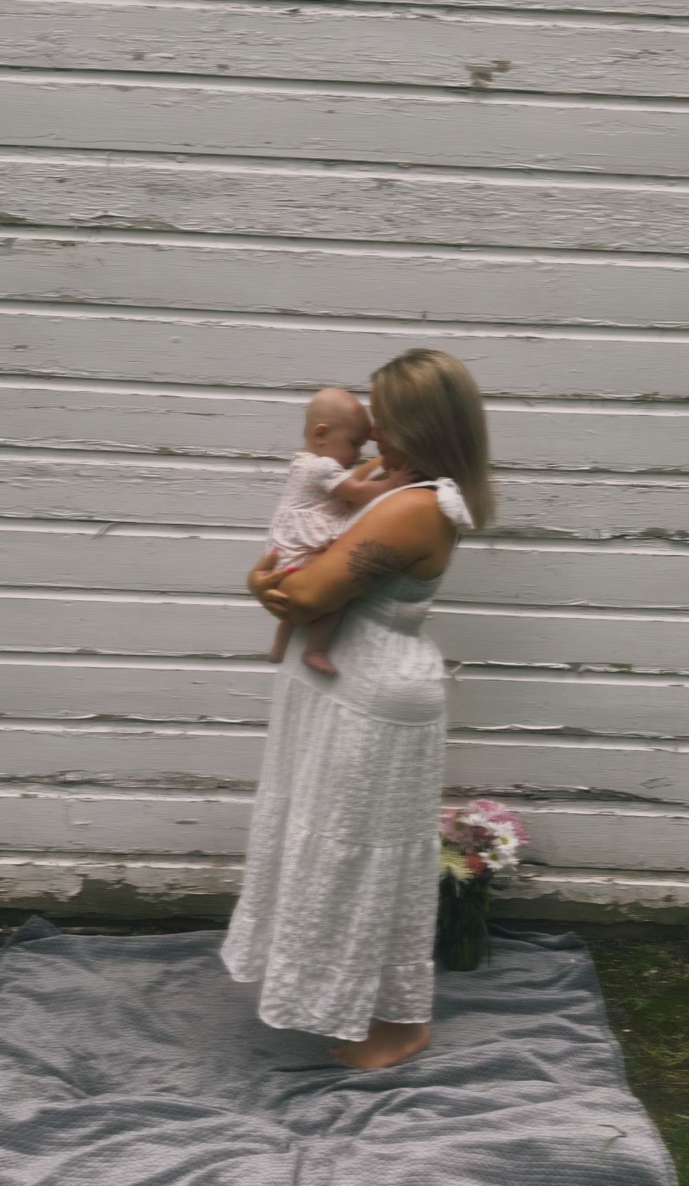 Mother holding her baby during an outdoor motherhood photography session