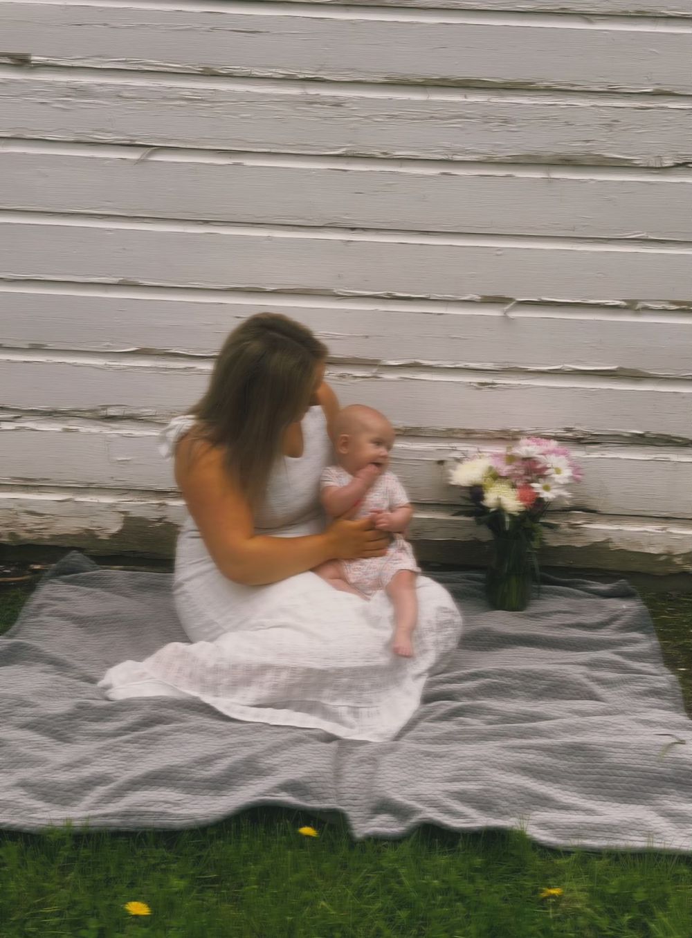 Mother sitting with her baby during an outdoor motherhood photography session
