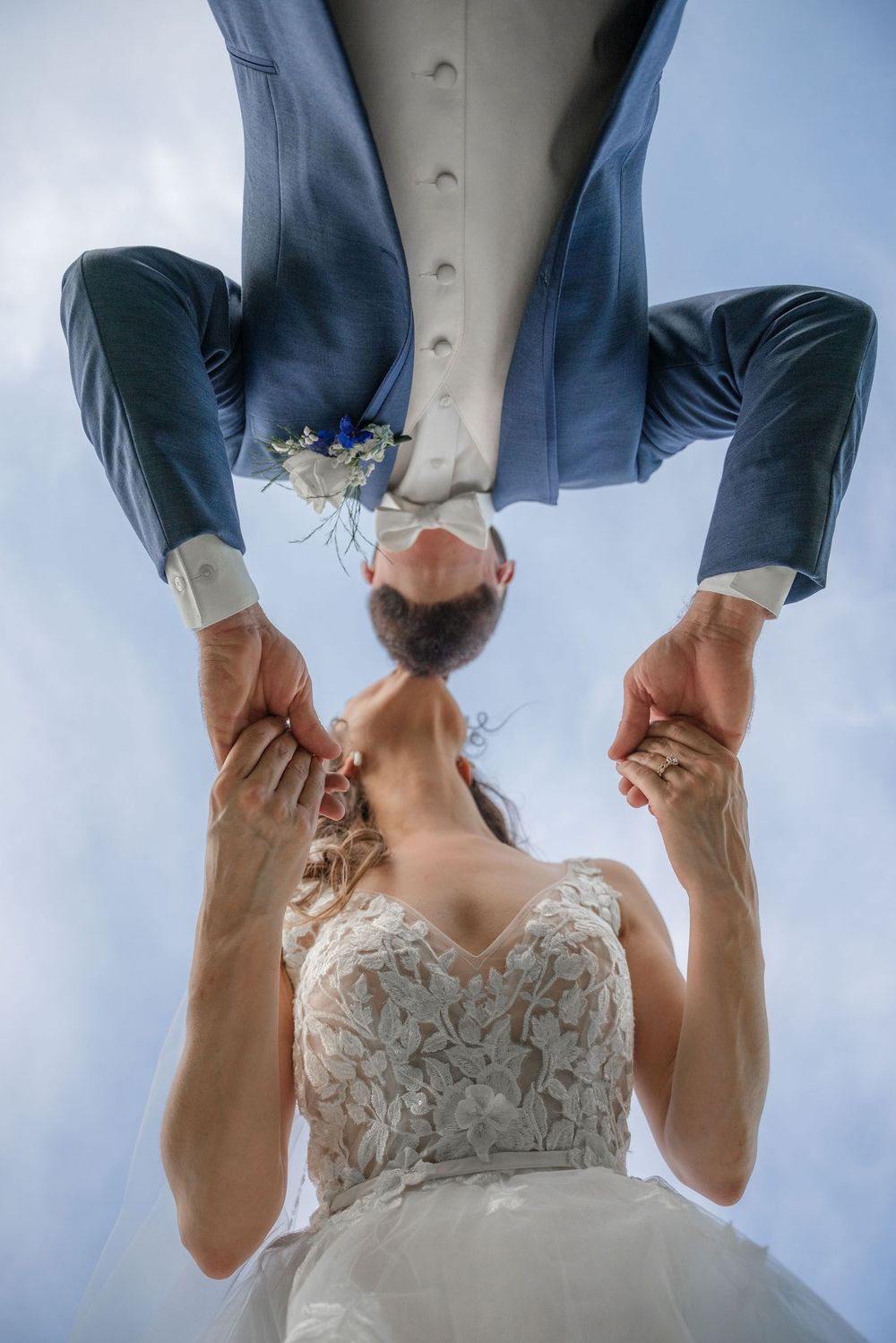 Bride and groom kissing photographed from an upside down angle at Tradition Town Hall in Tradition, FL