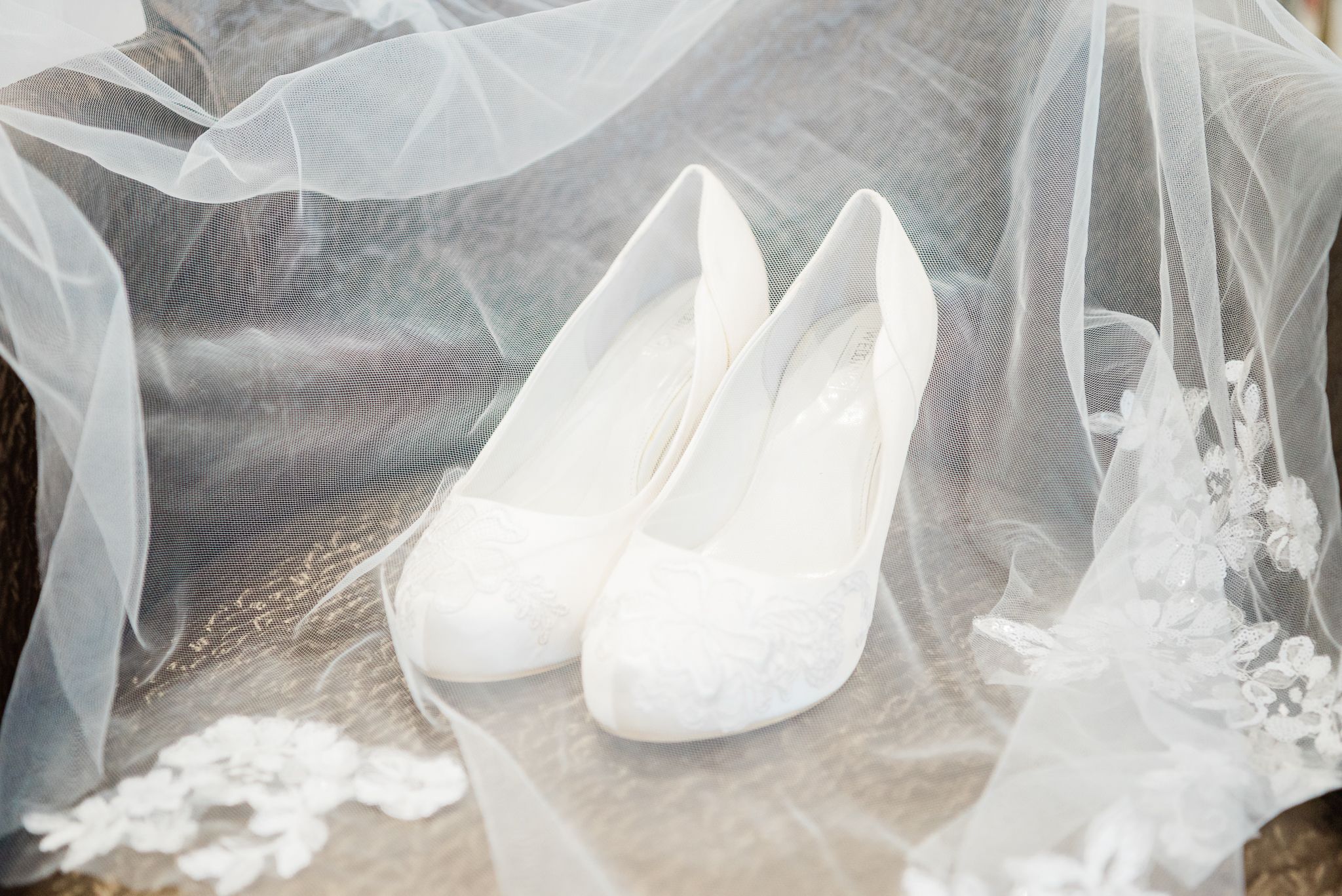 Brides shoes underneath the veil