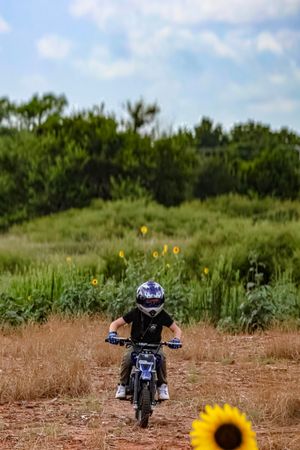 Motocross rider on a dirt bike outdoors during an action sports photography session in Oklahoma.