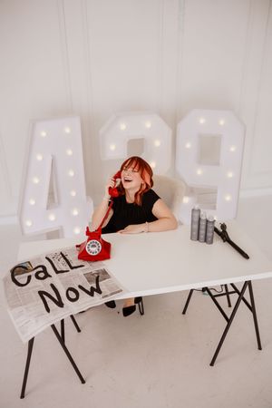 Business owner posing at a branded table during a creative small business branding photography session.