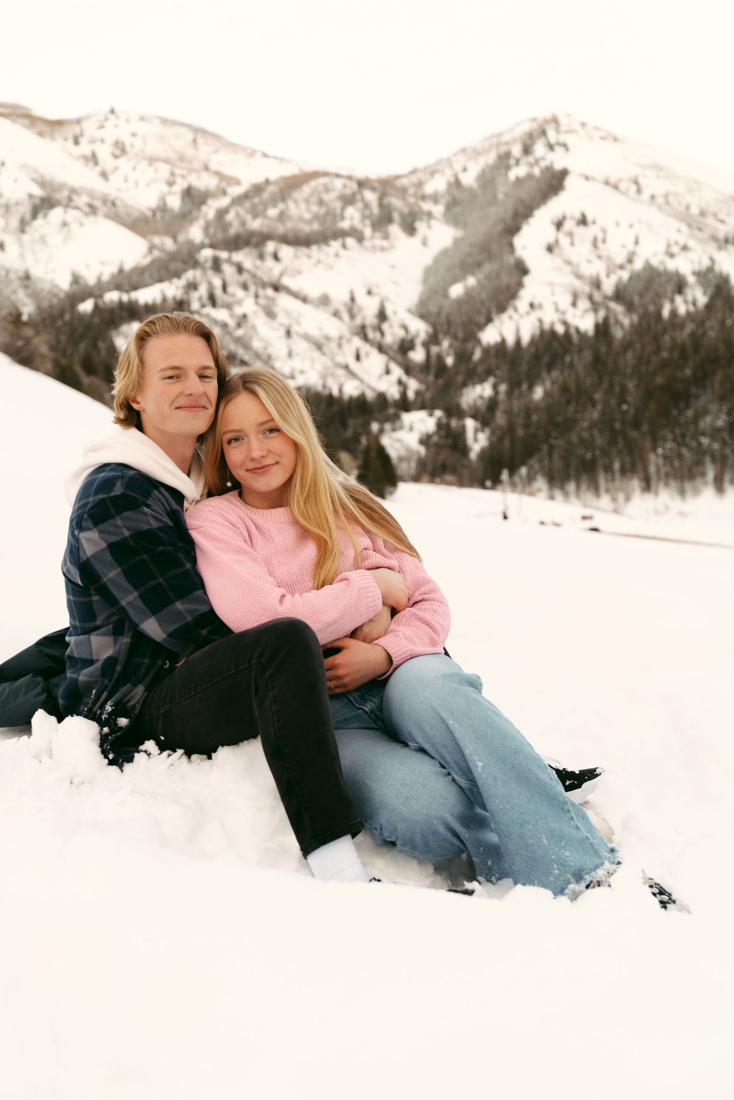 Smiling couple in blue and pink outfits for engagement photos