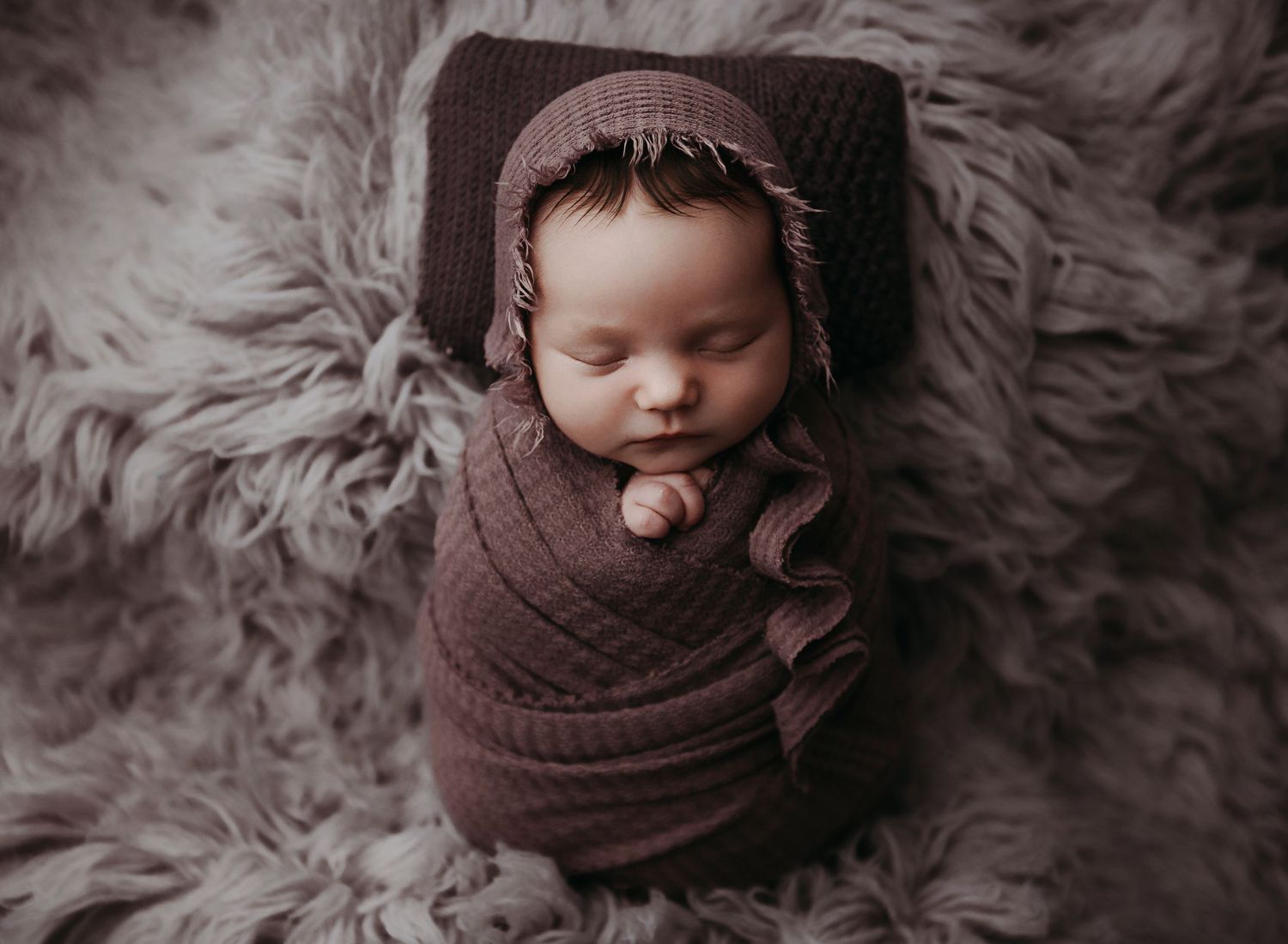 Swaddled newborn portrait session shot in our Nacogdoches portrait studio.