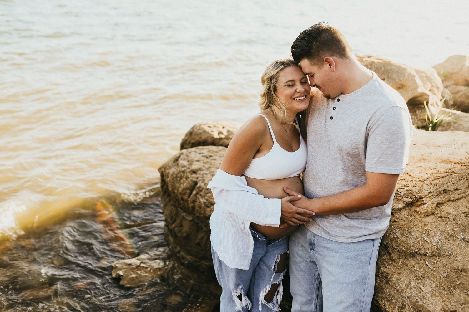Sunset maternity photography at Lake Grapevine with expecting parents by the water
