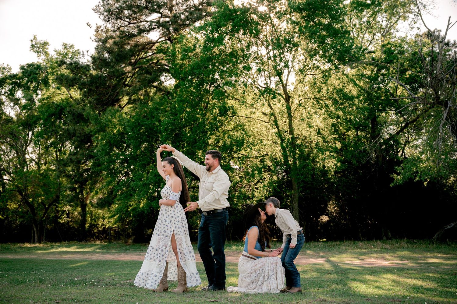 Father twirling his teenage daughter during a candid family photo session at Good Vibes Farm in Tomball, Texas.