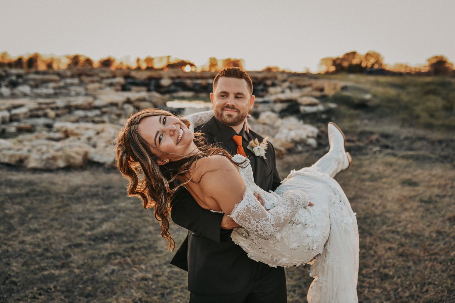 Newlyweds posing outside the rustic ranch buildings
